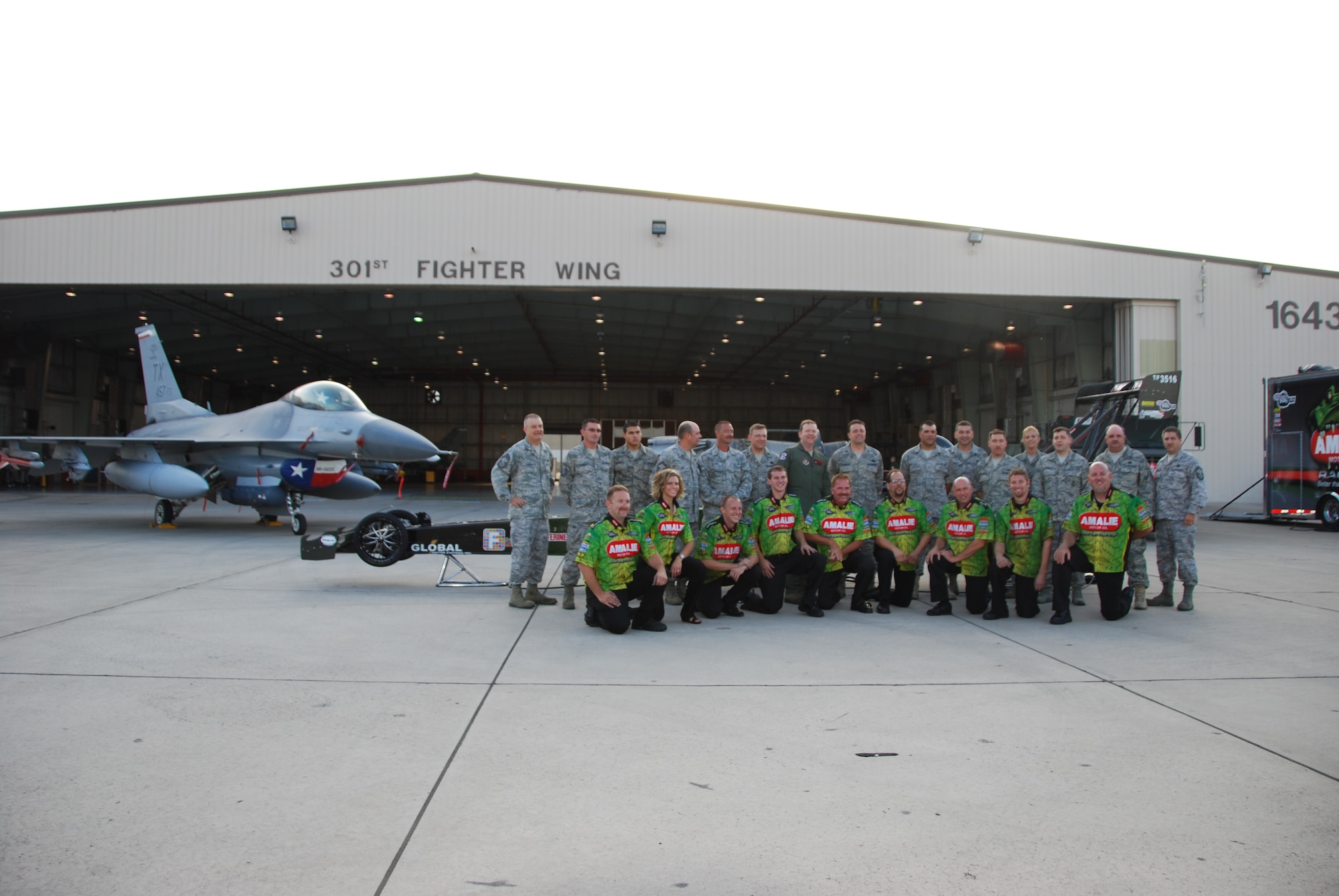 Driver of the Amalie Oil Top Fuel dragster, Mr. Terry McMillen and his team join their counterparts in the 301st Fighter Wing Maintenance Group. McMillen and his crew recently visited the 301st Fighter Wing before racing at a Dallas-area event. (Air Force Photo/Tech. Sgt. Shawn McCowan)