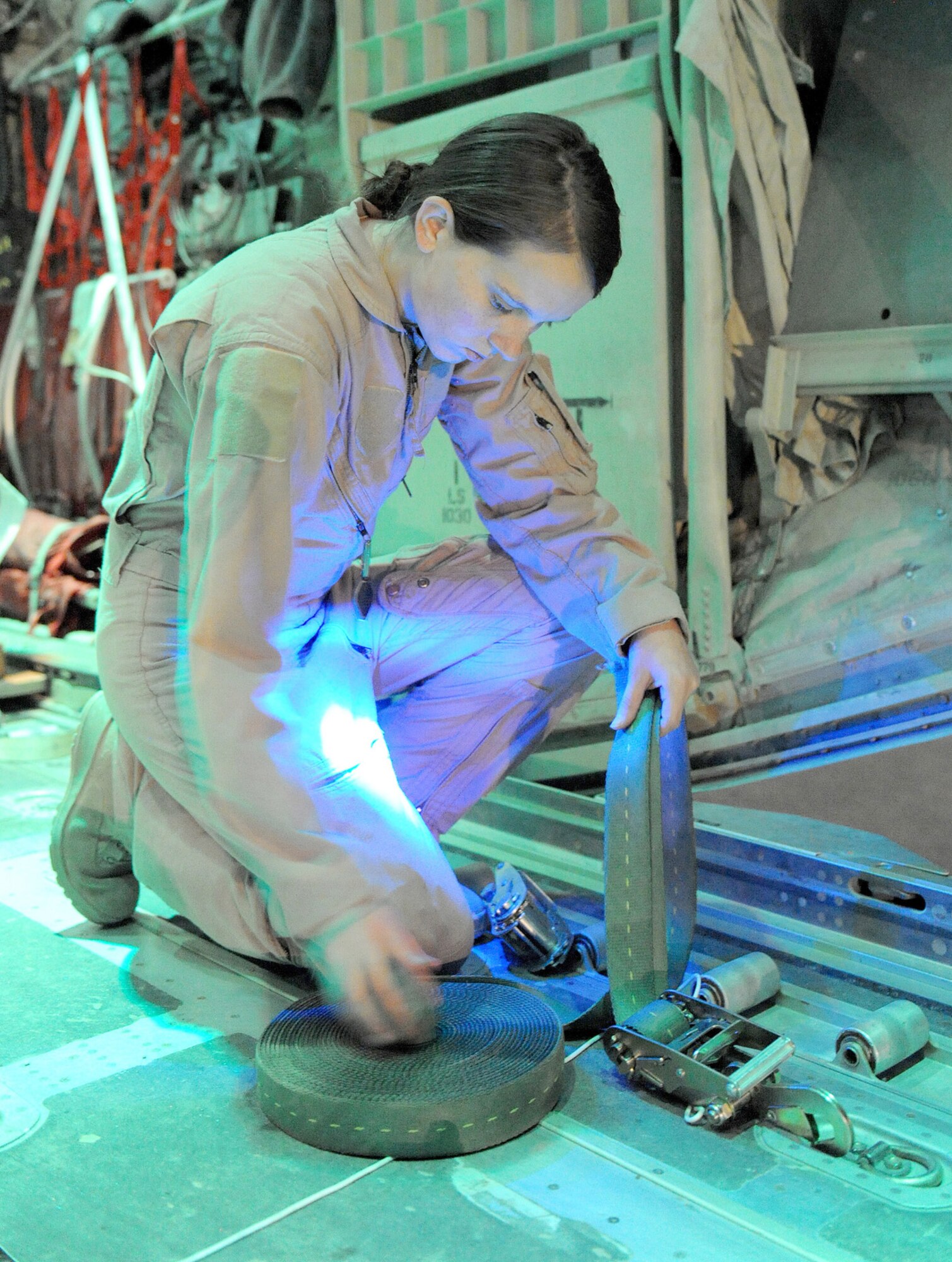 Airman 1st Class Rachael Orazine prepares to strap airdrop bundles on a C-130J Super Hercules Oct. 7, 2010, for a remote forward operating base in Afghanistan.  Airman Orazine is a loadmaster with the 772nd Expeditionary Airlift Squadron, and hails from Gulfport, Miss. (U.S. Air Force photo/Tech. Sgt. Chad Chisholm)