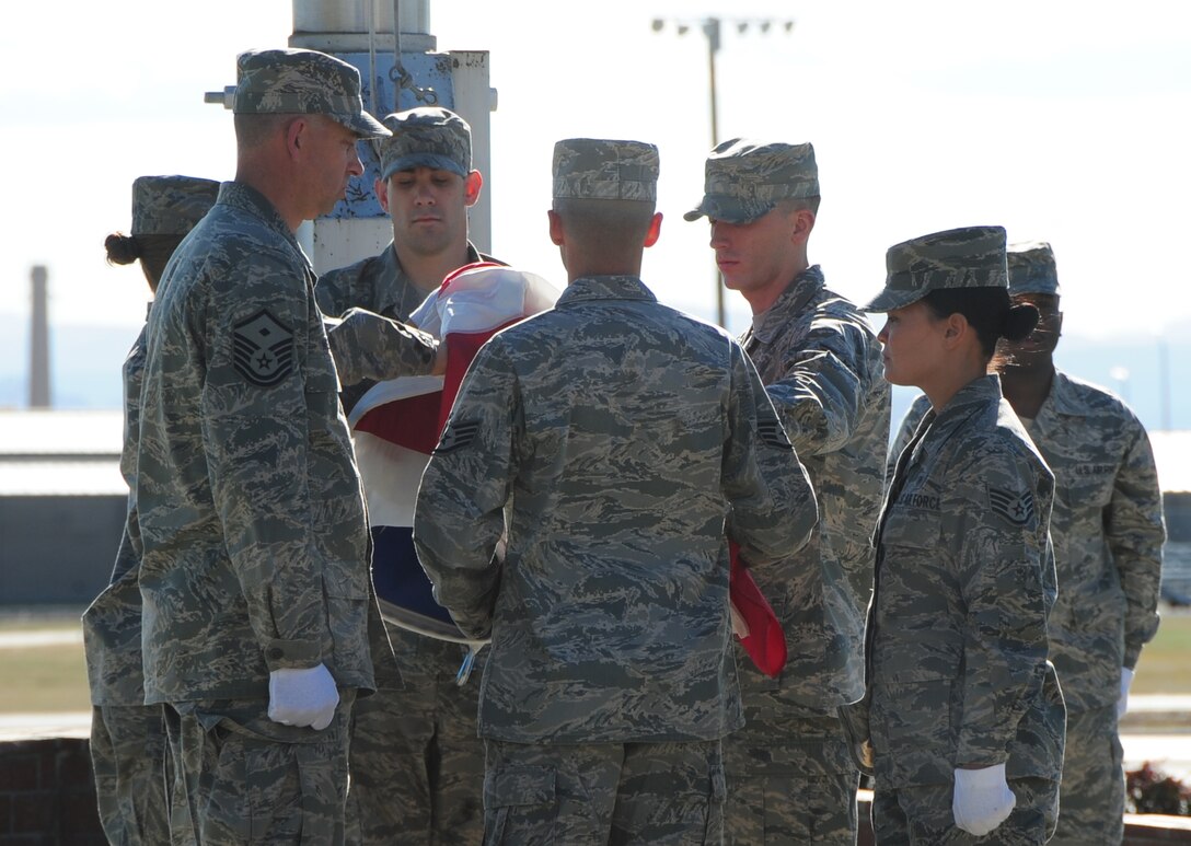 ELLSWORTH AIR FORCE BASE, S.D. -- Base Honor Guard Airmen fold the American flag during the prisoner of War/Missing in Action retreat ceremony, Oct. 1.  There are approximately 100,000 American armed forces personnel listed as either POW or MIA. (U.S. Air Force photo/Airman 1st Class Anthony Sanchelli)
