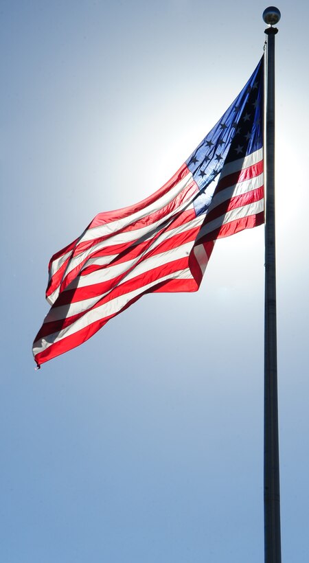 ELLSWORTH AIR FORCE BASE, S.D. -- The base flag flies high before being lowered during the Prisoner of War/Missing in Action retreat ceremony, Oct. 1.  POW/MIA day is a day of remembrance for all Americans who were and are POW's and MIA. (U.S. Air Force photo/Airman 1st Class Anthony Sanchelli)

