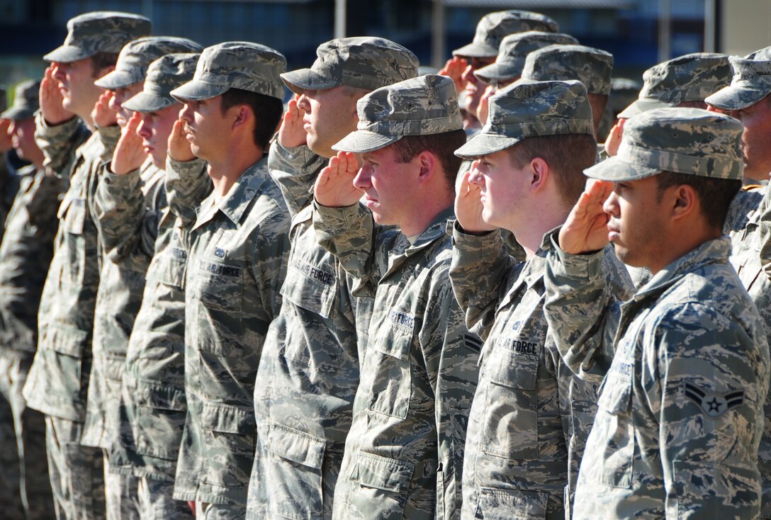 ELLSWORTH AIR FORCE BASE, S.D. - 28th Bomb Wing Airmen stand in formation and salute the American flag during the prisoner of War/Missing in Action retreat ceremony, Oct. 1.  As part of POW/MIA day, Airmen participated in a 5k run, a motorcycle ride to the Black Hills National Cemetery prior to the retreat ceremony. (U.S. Air Force photo/Airman 1st Class Anthony Sanchelli)
