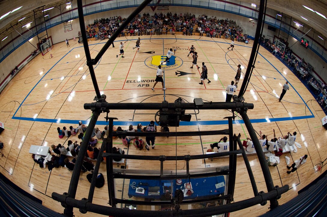 ELLSWORTH AIR FORCE BASE, S.D. - The Ellsworth All Stars charge the Harlem Ambassadors during a Basketball show at the Bellamy Fitness Center Oct. 8. The Harlem Ambassadors have been touring the country since 1998, and have had two teams on tour since 2002. Their mission is to provide wholesome family entertainment while also promoting strong values such as staying in school and staying off drugs. (U.S. Air Force photo/Tech. Sgt. Nathan Gallahan)
