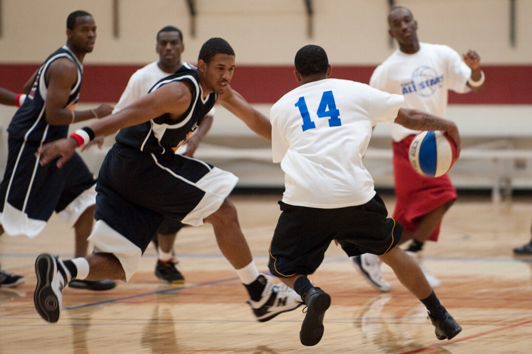 ELLSWORTH AIR FORCE BASE, S.D. - Airman 1st Class Walter Carney of the Ellsworth All Stars drives through the defenses of the Harlem Ambassadors during a basketball show at the Bellamy Fitness Center Oct. 8. The Harlem Ambassadors played a full game against the All Stars while incorporating various skits throughout the night. (U.S. Air Force photo/Tech. Sgt. Nathan Gallahan)
