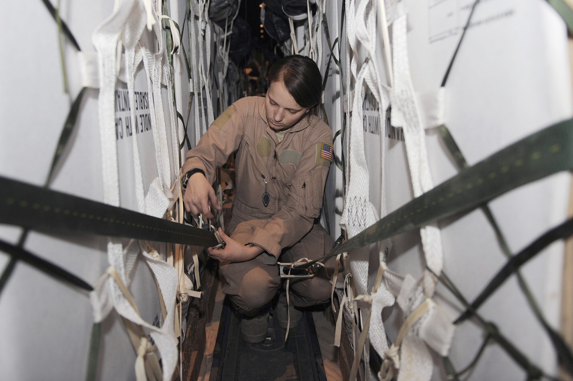Airman 1st Class Rachael Orazine secures a cargo strap to an airdrop bundle on a C-130J Super Hercules Oct. 7, 2010, at Kandahar Airfield, Afghanistan.  Airman Orazine is a loadmaster with the 772nd Expeditionary Airlift Squadron, and hails from Gulfport, Miss. (U.S. Air Force photo/Tech. Sgt. Chad Chisholm)