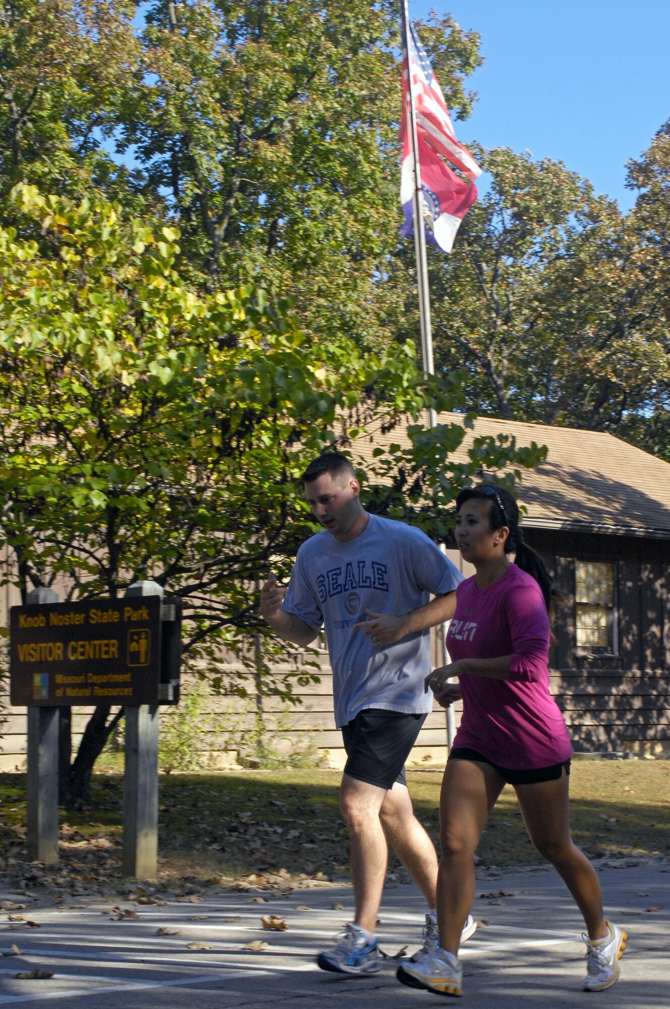 WHITEMAN AIR FORCE BASE, Mo. - Staff Sgt. Dustin Seale, 509th Munitions Squadron (left), and Mrs. Farrah Thompson, Extreme Military Training coach, run  Oct. 8 through Knob Noster State Park during an EMT session. Mrs. Thompson performs most workouts with her students and provides instruction for proper form on exercises. (U.S. Air Force photo/Senior Airman Jason Barebo)