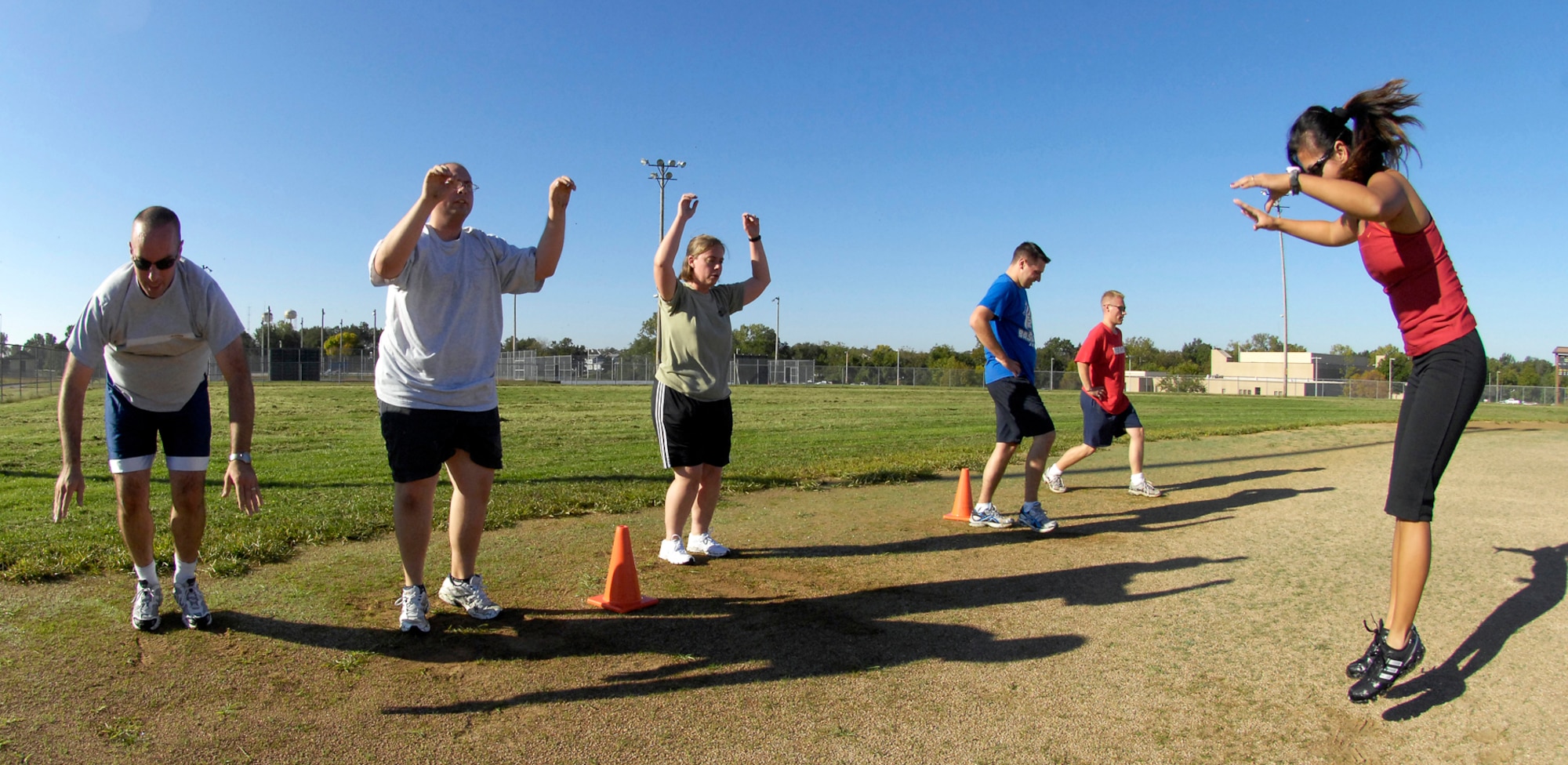 WHITEMAN AIR FORCE BASE, Mo. - Members of the morning Extreme Military Training session perform jump squats Sept. 29. EMT training sessions provide a variety of workout exercises and locations all focusing on passing the Air Force Physical training test. (U.S. Air Force photo/Senior Airman Jason Barebo)