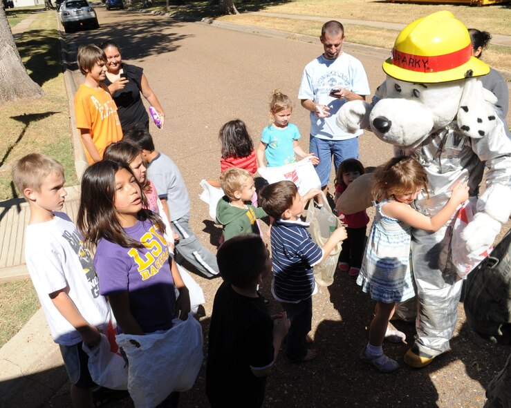 BARKSDALE AIR FORCE BASE, La. -- Fire mascot, Sparky the Fire Dog, is greeted by children in historical housing Oct. 3 during Fire Prevention Week. The fire department urged patrons when to check their smoke detectors and displayed the proper way to check and use their fire extinguishers. (U.S. Air Force photo/Airman 1st Class Sean Martin)(Released)