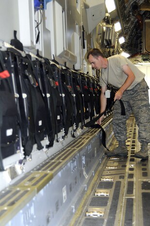 Staff Sgt. Nathan Horrocks from the 437th Aircraft Maintenance Squadron onboard Join Base Charleston-Air Base, stows a seat aboard a C-17 aircraft Tuesday, Oct. 5. (U.S. Navy photo/Mass Communication Specialist 1st Class Jennifer Hudson)