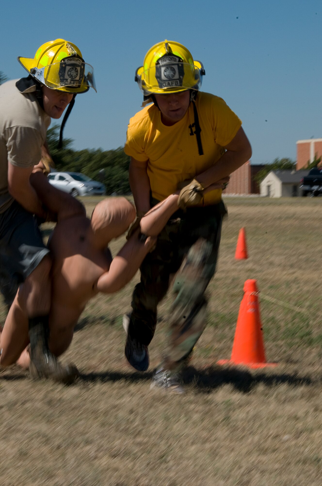 GOODFELLOW AIR FORCE BASE, Texas – Capt. Michael Schrama and 2nd Lt. J. Michael Pulli, pull a mannequin during the dummy drag obstacle portion of the 6th annual Firefighter Muster at the fire station Oct. 8. 11 teams of four signed up for the  The event, which was part of the Fire Prevention Awareness Week. (U.S. Air Force photo/ Senior Airman Tong Duong)