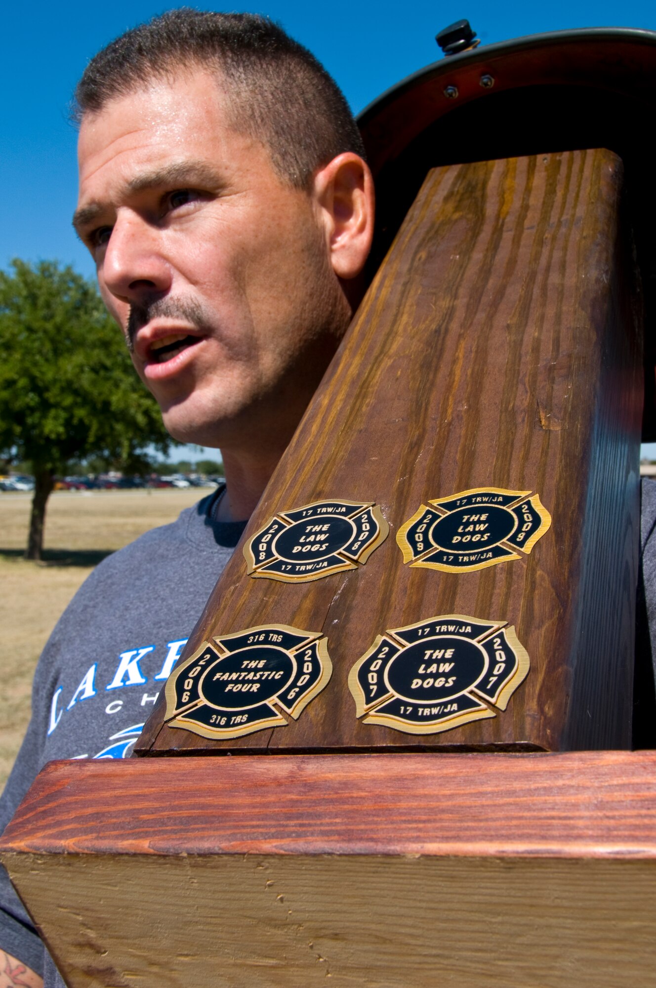 GOODFELLOW AIR FORCE BASE, Texas – Master Sgt. Christopher Hernandez, 17th Judge Advocate, holds the trophy after the Law Dogs defeated 10 other teams, during the 6th annual Firefighter Muster at fire station Oct. 8. The Law Dogs completed the course in 05:25 to capture the win for a fourth straight year, claiming five of the six years of the muster’s existence. (U.S. Air Force photo/ Senior Airman Tong Duong)