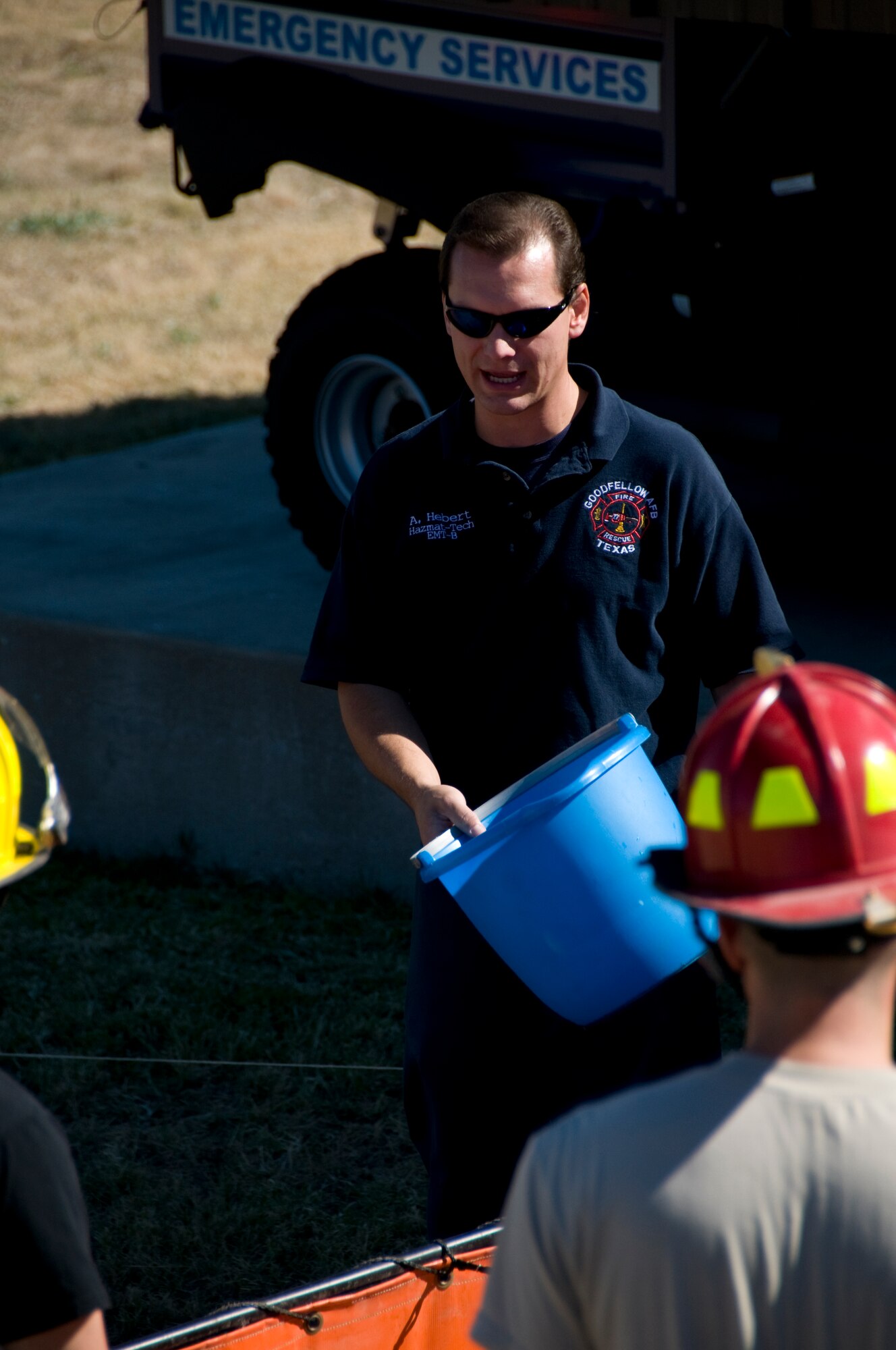 GOODFELLOW AIR FORCE BASE, Texas – Alan Hebert, 17th Civil Engineer Squadron Hazardous Material technician, explains the rules for the bucket brigade course during the 6th annual Firefighter Muster at fire station Oct. 8. 11 teams of four competed in eight obstacles for a chance at the title, a year of bragging rights and $100 cash prize. (U.S. Air Force photo/ Senior Airman Tong Duong)