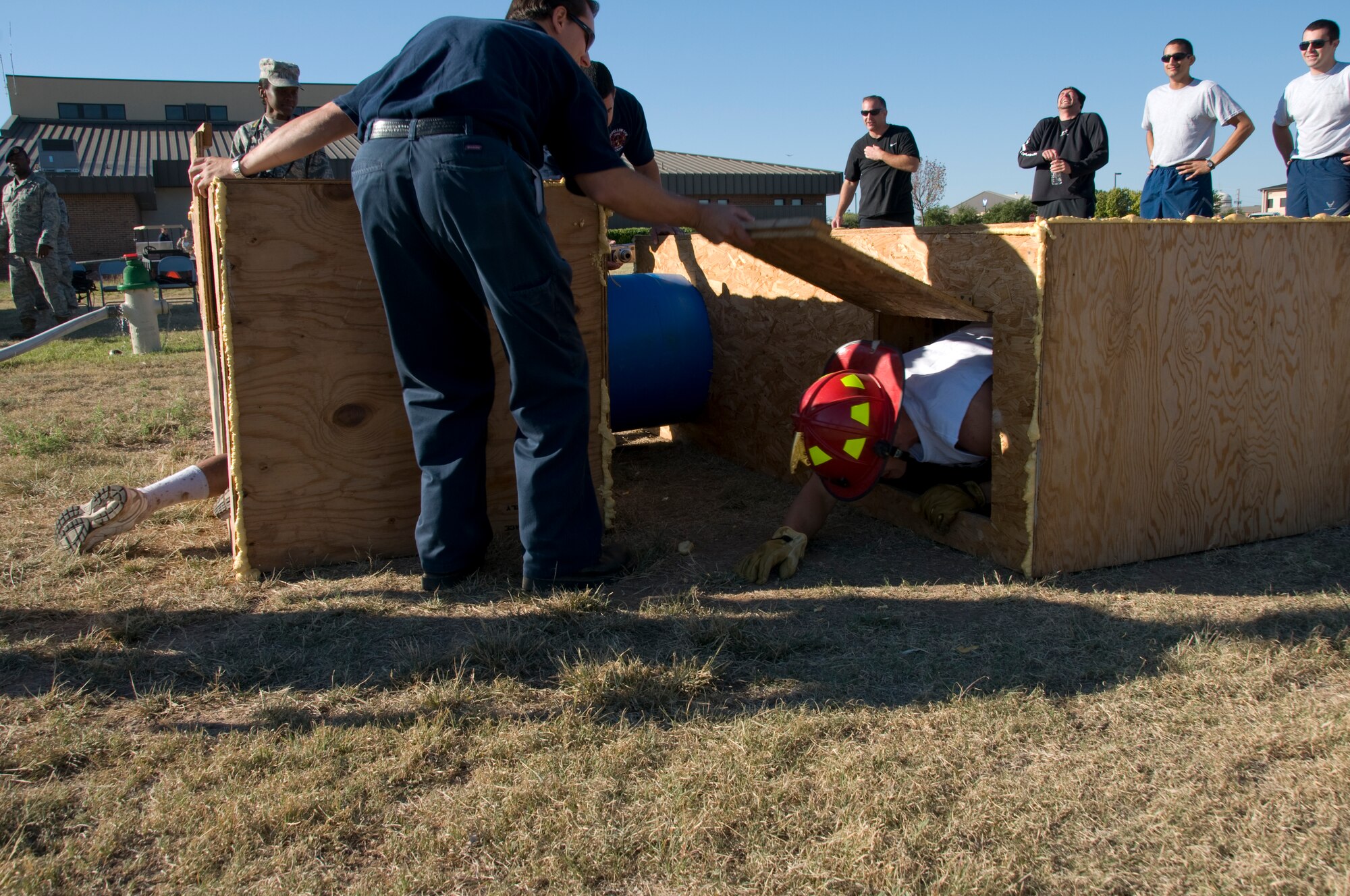 GOODFELLOW AIR FORCE BASE, Texas – Alan Hebert, 17th Civil Engineer Squadron Hazardous Material  technician, holds doors open for competitors during a confined space crawl at the fire station Oct. 8. Each of four team members must successfully navigate the course before they can move on to the next obstacle. (U.S. Air Force photo/ Senior Airman Tong Duong)