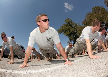 Airmen do push-ups in honor of fallen special tactic Airmen during an opening ceremony of the Walk for the Fallen at Lackland's Training Annex Oct. 9. (U.S. Air Force photo/Robbin Cresswell)