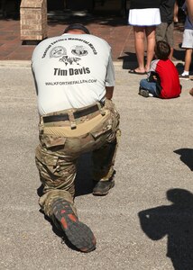 An Airman says a prayer before the start of the Walk for the Fallen Oct. 9. Also called the Tim Davis Special Tactics Memorial March, the 860-mile trek will stretch across five states and will consist of six teams walking 24 hours a day, in a relay format. (U.S. Air Force photo/Robbin Cresswell)
 