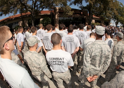 Airmen gather to honor fallen special tactics Airmen during a ceremony Oct. 9 that marked the start of the Walk for the Fallen. Fifteen Airmen, marching in six teams, will relay through five states, averaging 15-20 miles per leg. Each team will walk approximately 150 miles during the trek, carrying a 50-pound ruck sack and a commemorative baton engraved with a fallen Airman's name. (U.S. Air Force photo/Robbin Cresswell) 
 