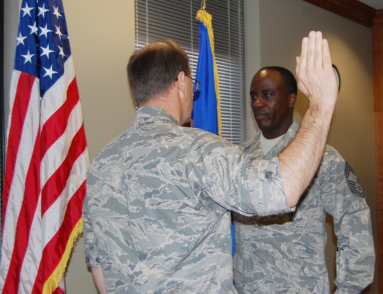 Col. Brunke, 926th Group commander, administers the Oath of Enlistment to Chief Master Sgt. Jones during his promotion ceremony Oct. 2 in the 926th GP conference room. Chief Jones is the 926th GP's newest senior non-commissioned officer to join the top one percent of the enlisted force promoted to the rank of chief. As the group superintendent, he advises the commander on matters influencing the health, morale, welfare and effective utilization of more than 506 active Reserve members.