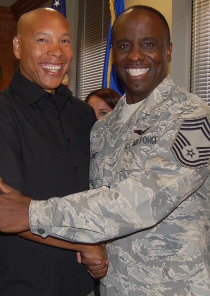 Chief Master Sgt. Jones (right), 926th Group superintendent, shakes hands with retired Chief Master Sgt. Maxwell Oct. 2 in the 926th GP conference room during his promotion ceremony. Chief Jones is the 926th GP's newest senior non-commissioned officer to join the top one percent of the enlisted force promoted to the rank of chief. As the group superintendent, he advises the commander on matters influencing the health, morale, welfare and effective utilization of more than 506 active Reserve members.