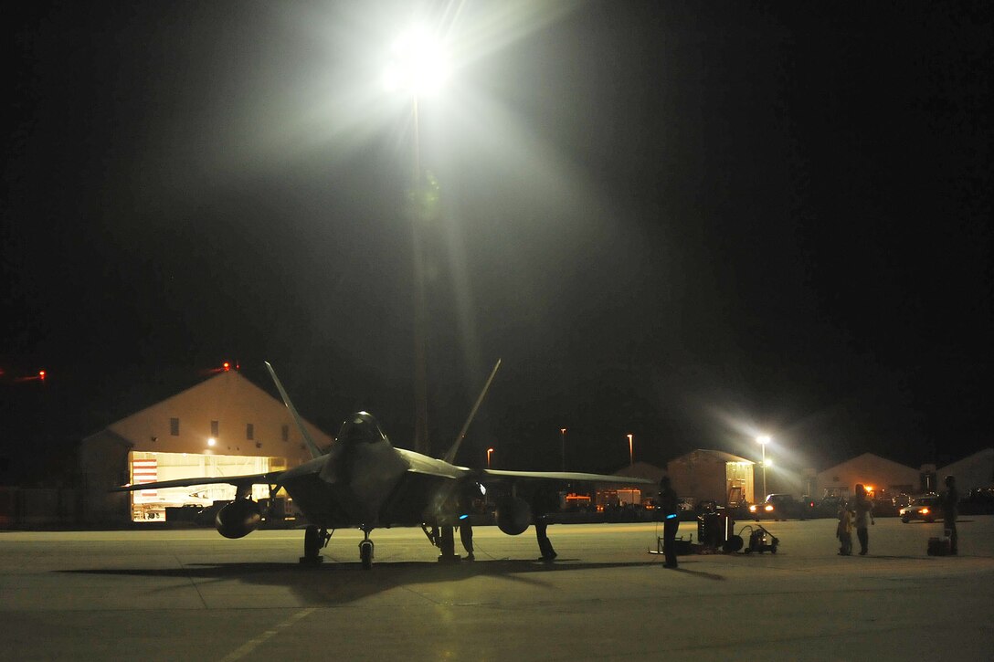 LANGLEY AIR FORCE BASE, Va -- Lt. Col. Peter Fesler, 1 Fighter Wing, 27 Fighter Squadron commander, taxis the aircraft, while his family waits to greet him upon his return from Guam.  A team of eight pilots from the 27th FS were deployed for four months in support of operations in the Pacific. (U.S. Air Force photo/Staff Sgt. Ashley Hawkins)(RELEASED)