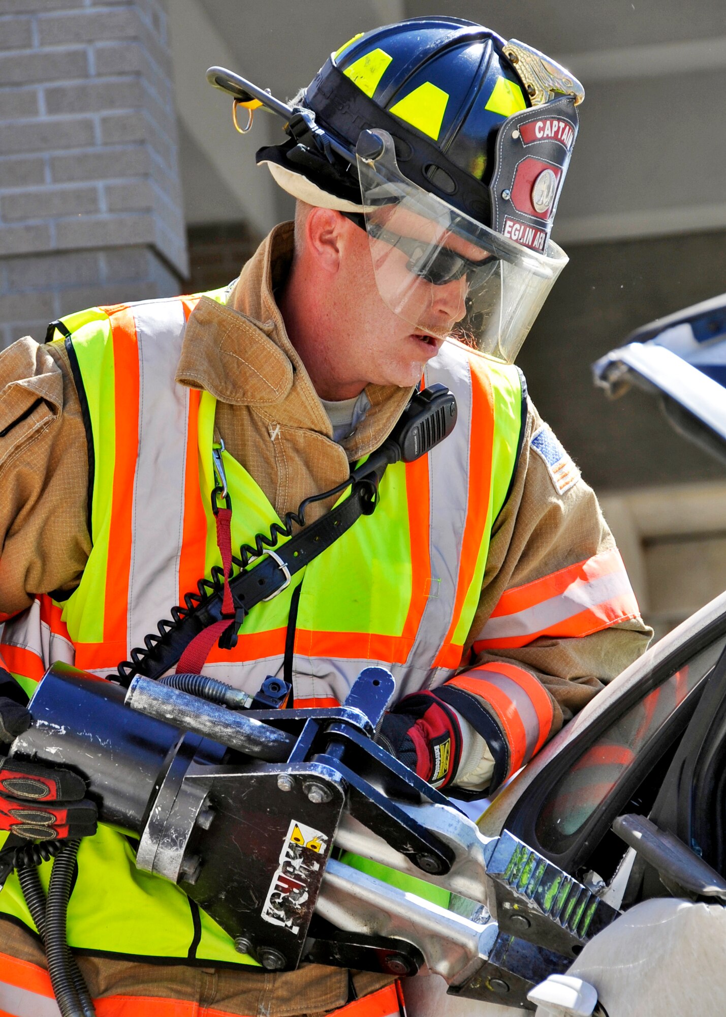 Staff Sgt. Tim Llewellyn, 96th Civil Engineer Squadron firefighter, uses the “jaws of life” tool to open a door during the car extraction demonstration at Eglin’s base exchange Oct.  8.  The firefighters demonstrated how quickly they can open up a car to free a trapped victim of an accident.  The demonstration closed out fire prevention week at Eglin.  (U.S. Air Force photo/Samuel King Jr.)