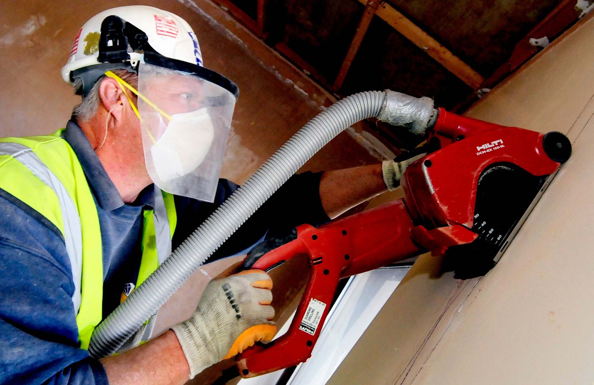 RAF MILDENHALL, England -- Chris Hunt, a local contractor, chases a wall with a wall chaser saw so that it can be rewired during the remodeling at Building 210 here Oct. 12. The remodeling of the dorms is just one of the many quality of life upgrade projects being done around the base. (U.S. Air Force photo/Senior Airman Ethan Morgan)

