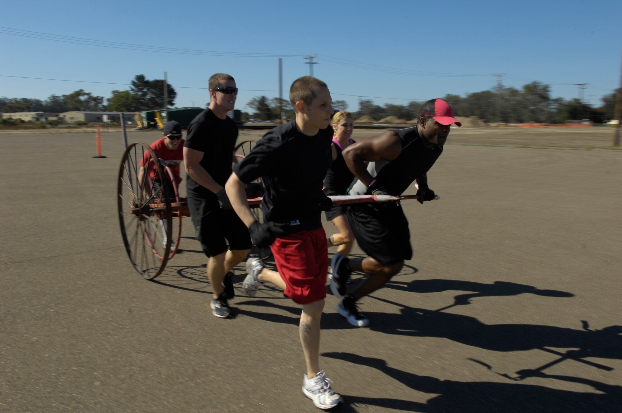 VANDENBERG AIR FORCE BASE, Calif. – The 30th Medical Group team completes an obstacle course by pulling a fire carriage during the Fire Muster held at the base parade grounds here Friday, Oct. 8, 2010. The Fire Muster is a friendly competition between squadrons that demonstrates what a firefighter faces both physically and mentally. (U.S. Air Force photo/Airman 1st Class Lael Huss) 