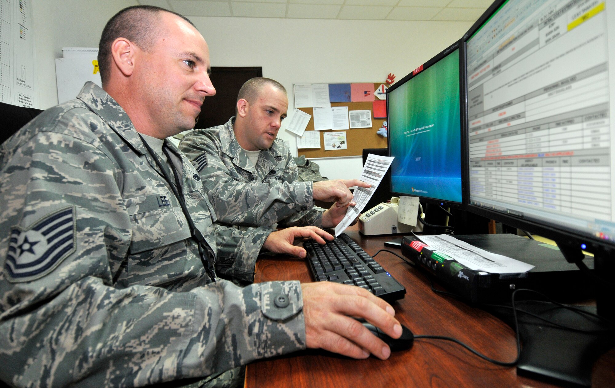Tech. Sgts. William Lee and Dennis Basch, 332nd Expeditionary Maintenance Group senior controllers, verify a checklist for accuracy, guaranteeing the correct information is provided to wing leadership Oct. 1, 2010, Joint Base Balad, Iraq. Checklists ensure the correct steps are followed when working. Sergeant Lee is a native of Phoenix, Ariz., deployed from Misawa Air Base, Japan. Sergeant Basch is a native of Colorado Springs, Colo., deployed from Offutt Air Force Base, Neb. (U.S. Air Force photo/Tech. Sgt. Phillip Butterfield) 