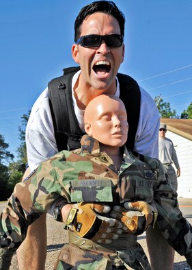 Maj. Mike Borders, 96th Security Forces Squadron, lifts the 125-pound dummy during the first sergeants vs commanders’ challenge Oct. 7 at Eglin Air Force Base, Fla.  The challenge represented the physical training course new Airmen must accomplish to become Air Force firefighters.  The course included hose carrying, dragging and pulling, victim carry and climbing 10 steps up a ladder five times and more.  Major Borders had the overall best time, completing the course in four minutes, eight seconds.   The shirts beat the commanders for a second year by a full minute with a combined time of 18 minutes, 11 seconds.   (U.S. Air Force photo/Samuel King Jr.)