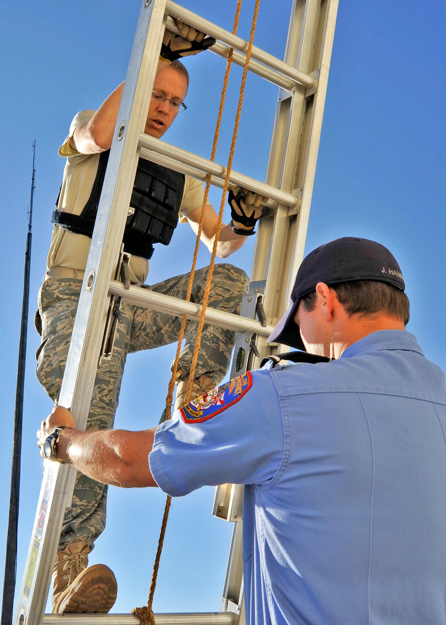Maj. David Meissen, 96th Civil Engineer Squadron, moves back down the ladder during the first sergeants vs commanders’ challenge Oct. 7 at Eglin Air Force Base, Fla.  The challenge represented the physical training course new Airmen must accomplish to become Air Force firefighters.  The course included hose carrying, dragging and pulling, victim carry and climbing 10 steps up a ladder five times and more.   The shirts beat the commanders for a second year by a full minute with a combined time of 18 minutes, 11 seconds.   (U.S. Air Force photo/Samuel King Jr.)