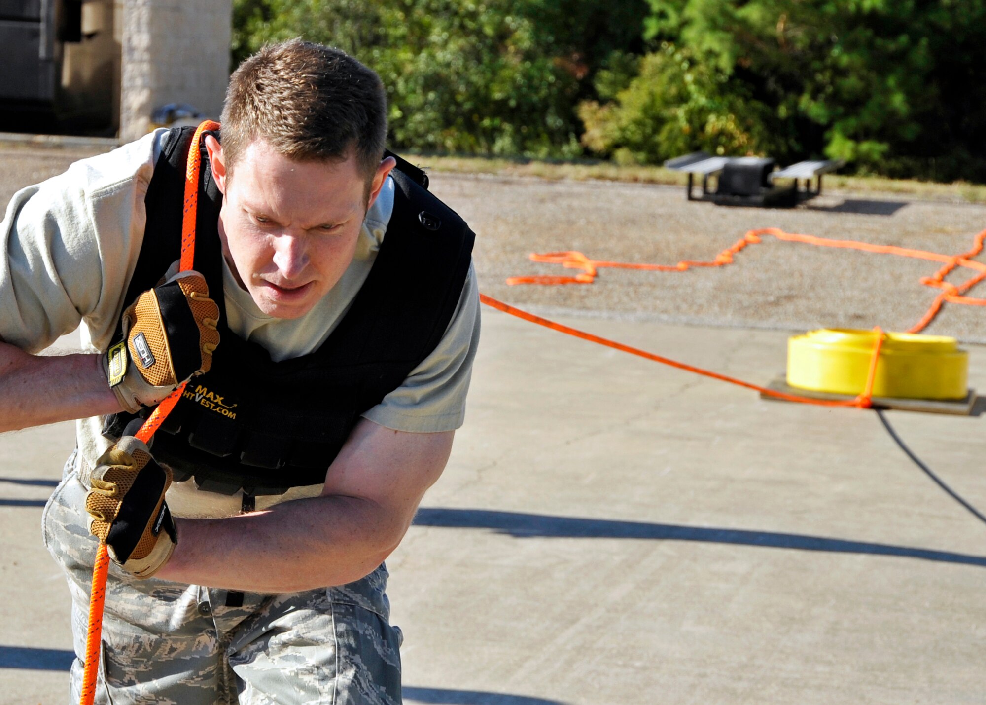 Maj. David Osterman, 96th Ground Combat Training Squadron, pulls a hose back to the line during the first sergeants vs commanders’ challenge Oct. 7 at Eglin Air Force Base, Fla.  The challenge represented the physical training course new Airmen must accomplish to become Air Force firefighters.  The course included hose carrying, dragging and pulling, victim carry and climbing 10 steps up a ladder five times and more.   The shirts beat the commanders for a second year by a full minute with a combined time of 18 minutes, 11 seconds.   (U.S. Air Force photo/Samuel King Jr.)