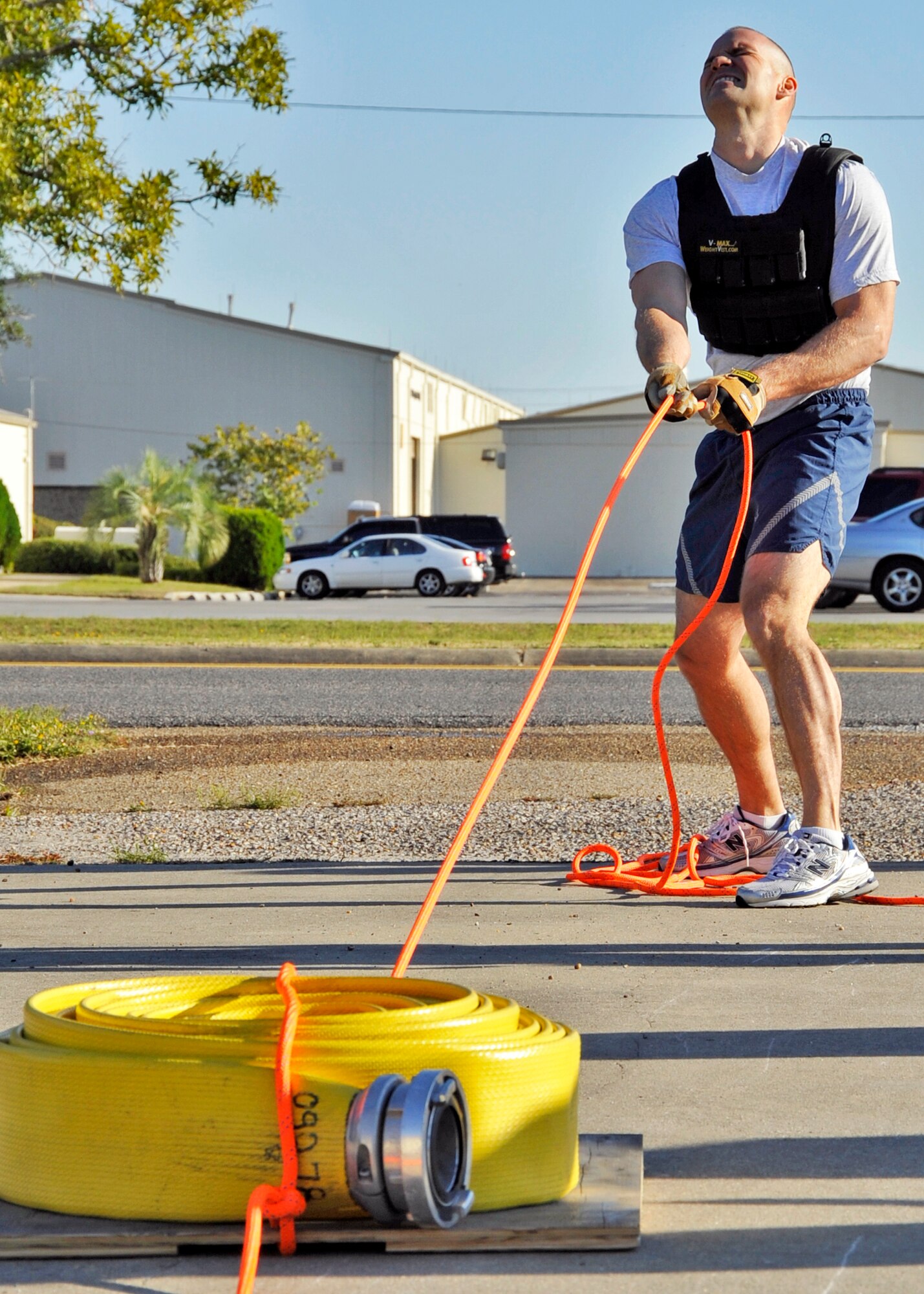 Master Sgt. Mike Hager, 33rd Maintenance Squadron, strains to pull the hose back to the line during the First Sergeants vs commanders’ challenge Oct. 7 at Eglin Air Force Base, Fla.  The challenge represented the physical training course new Airmen must accomplish to become Air Force firefighters.  The course included hose carrying, dragging and pulling, victim carry and climbing 10 steps up a ladder five times and more.  Sergeant Hager was the first on the course and had the best time among the shirts with four minutes 23 seconds.  The shirts beat the commanders for a second year by a full minute with a combined time of 18 minutes, 11 seconds.   (U.S. Air Force photo/Samuel King Jr.)