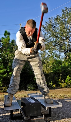 Staff Sgt. Tim Llewellyn, 96th Civil Engineer Squadron firefighter, brings the hammer down while demonstrating one of the challenges during the during the first sergeants vs commanders’ challenge Oct. 7 at Eglin Air Force Base, Fla.  The challenge represented the physical training course new Airmen must accomplish to become Air Force firefighters.  The course included hose carrying, dragging and pulling, victim carry and climbing 10 steps up a ladder five times and more.   The shirts beat the commanders for a second year by a full minute with a combined time of 18 minutes, 11 seconds.   (U.S. Air Force photo/Samuel King Jr.)