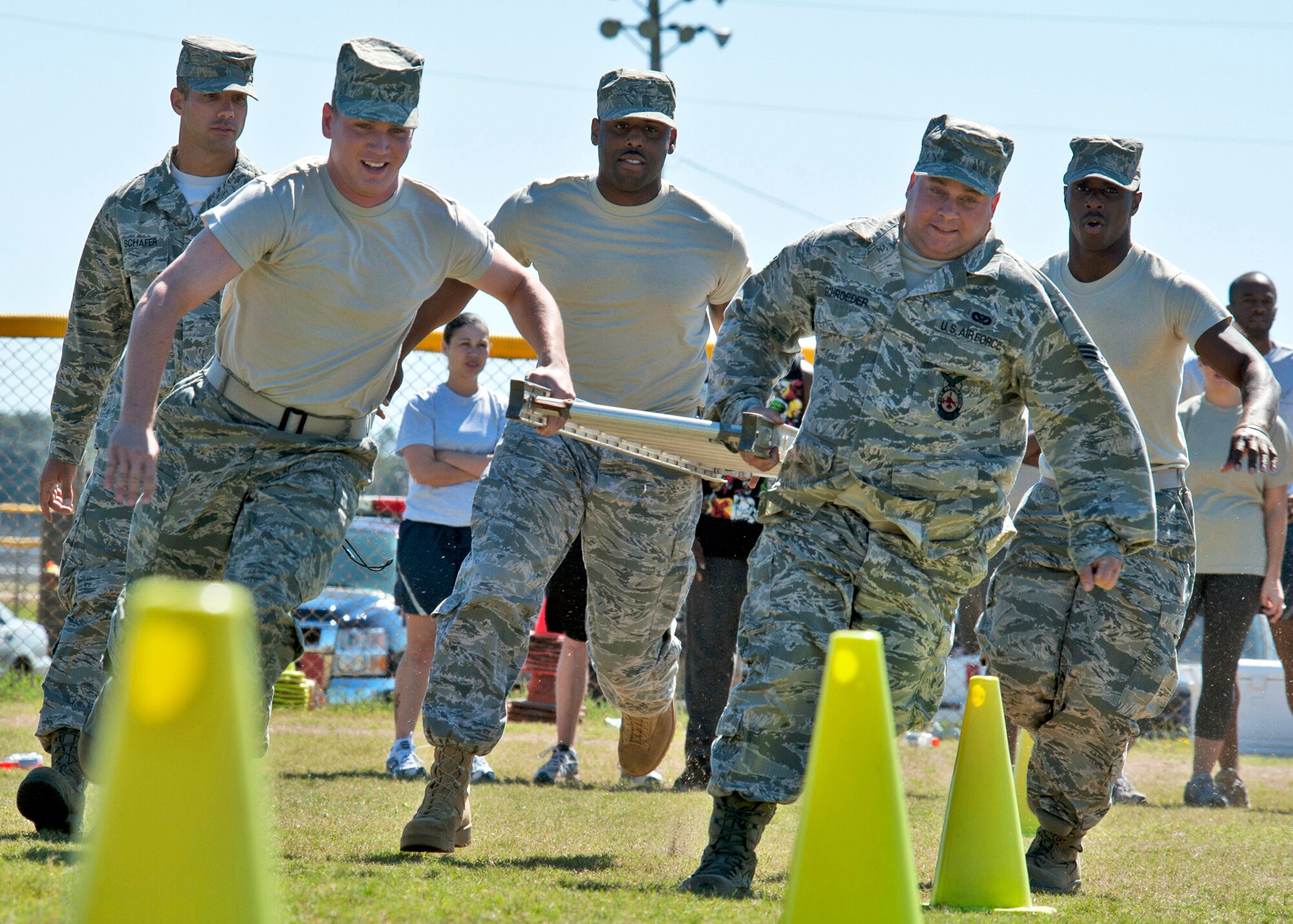 The firefighter team carries the litter around the cones during the Fire Muster Challenge Oct. 4 at Eglin Air Force Base, Fla.  Teams competed in the challenge that included a ladder and hose carry, fire engine pull, and water relay.  (U.S. Air Force photo/Samuel King Jr.)