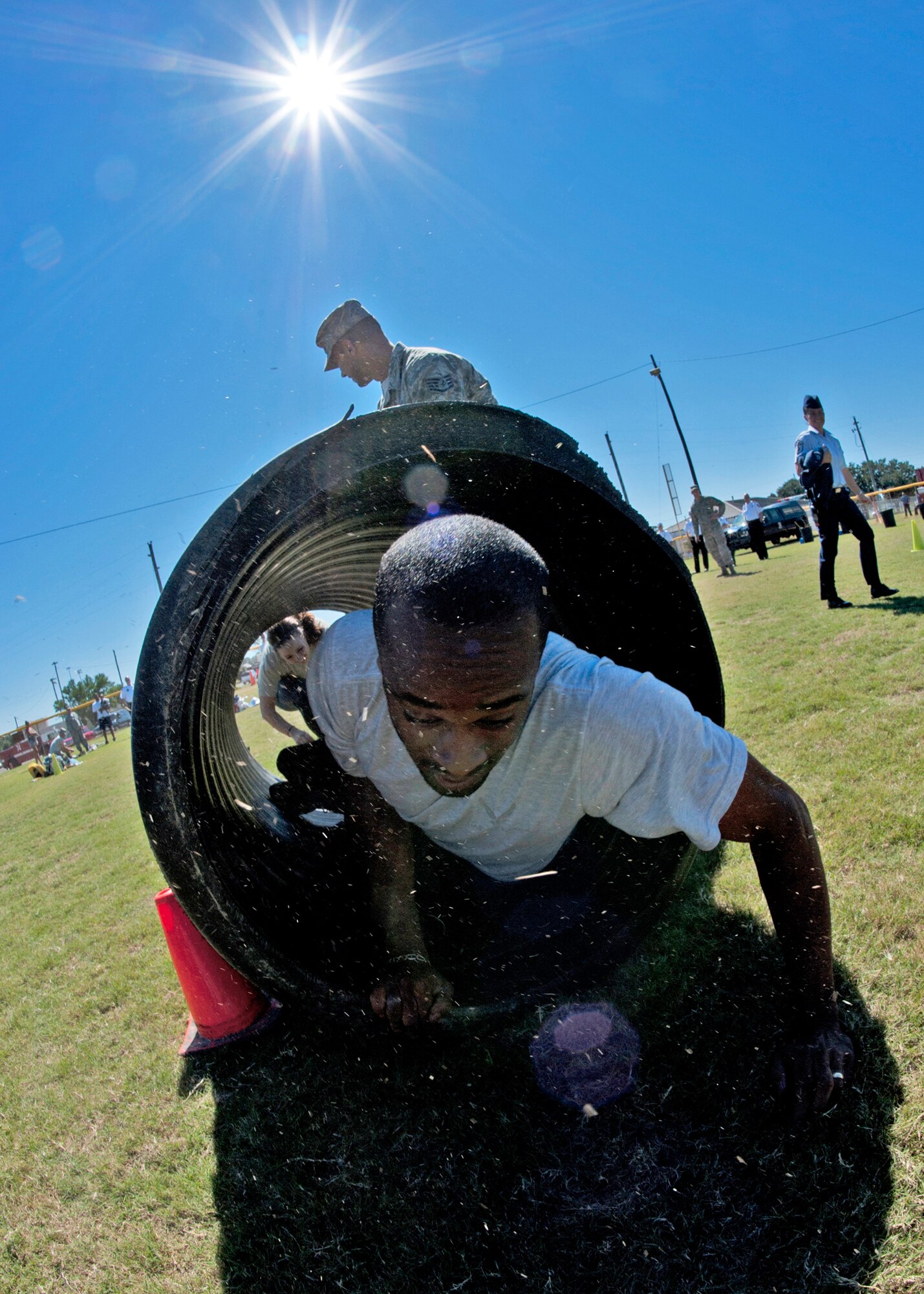 Senior Airman Cephas Stokling, 96th Comptroller Squadron, exits the cylinder during the Fire Muster Challenge Oct. 4 at Eglin Air Force Base, Fla.  Teams competed in the challenge that included a ladder and hose carry, fire engine pull, and water relay.  (U.S. Air Force photo/Samuel King Jr.)