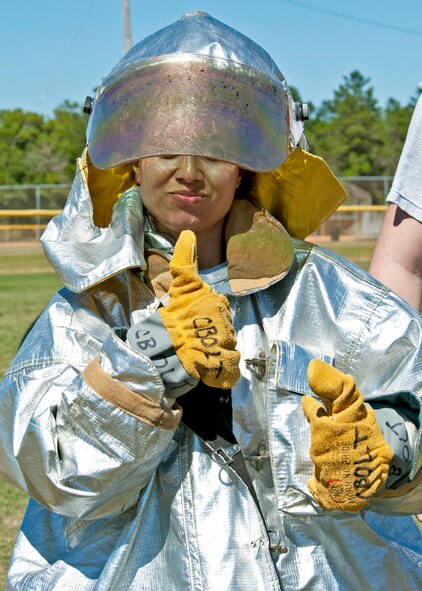 Capt. Maria Borders, 96th Civil Engineer Squadron, gives the thumbs-up after being dressed out in the fire suit first during the Fire Muster Challenge Oct. 4 at Eglin Air Force Base, Fla.  Teams competed in the challenge that included a ladder and hose carry, fire engine pull, and water relay.  (U.S. Air Force photo/Samuel King Jr.)