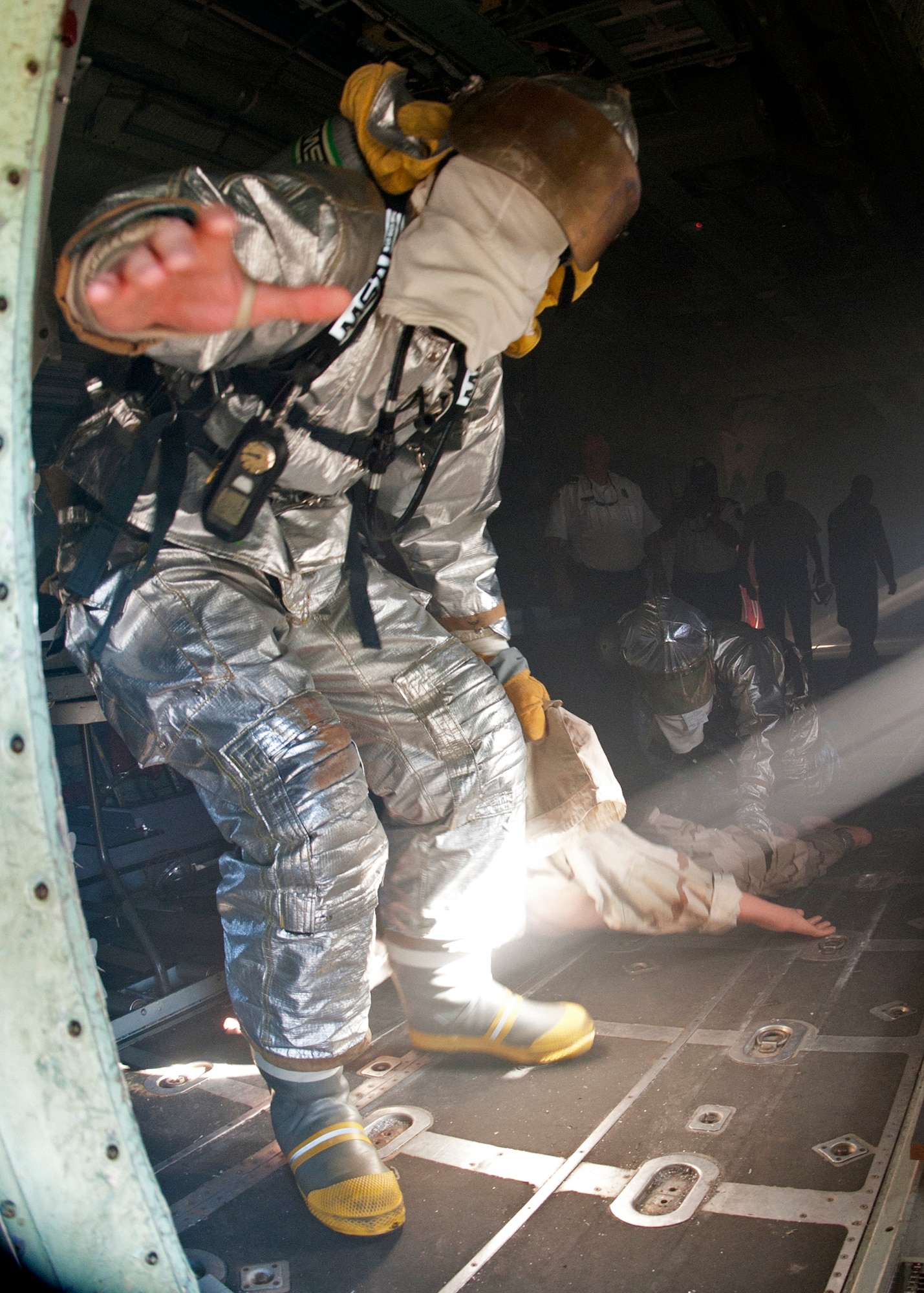 Senior Airman Nickolas Cox, 96th Civil Engineer Squadron, reaches out trying to find the exit door of the C-130 while in full fire gear and blindfolded during the commanders’ challenge event Oct. 4 at Eglin Air Force Base, Fla.  Base leaders and a partner had to enter the aircraft and find a simulated victim while blindfolded and in fire gear.  The exercise was to demonstrate first-hand what Air Force firefighters experience in the event of a fire.  (U.S. Air Force photo/Samuel King Jr.)