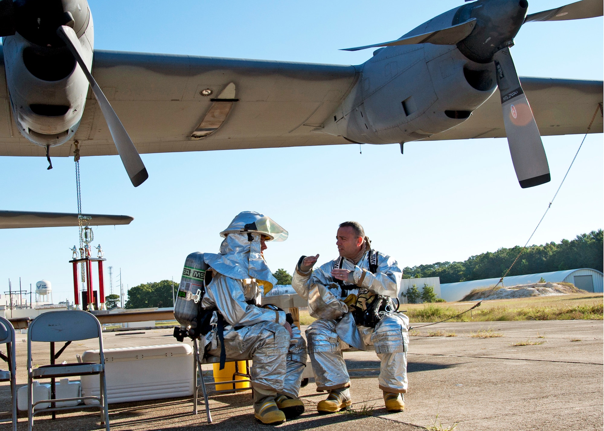 Col. Sal Nodjomian, 96th Air Base Wing commander, and Chief Master Sgt. Tom Westermeyer, 96th command chief, discuss their strategy prior to entering the commanders’ challenge event Oct. 4 at Eglin Air Force Base, Fla.  Base leaders and a partner had to enter the aircraft and find a simulated victim while blindfolded and in fire gear.  The exercise was to demonstrate first-hand what Air Force firefighters experience in the event of a fire.  (U.S. Air Force photo/Samuel King Jr.)