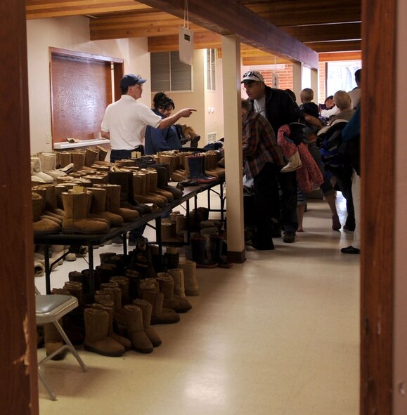 A Salvation Army employee directs a local community member toward more winter clothing during the Salvation Army winter clothing distribution Oct. 6 in Grand Forks, N.D. Volunteers from Grand Forks Air Force Base helped the Salvation Army with set-up, tear-down and handing out winter clothing items.  (U.S. Air Force photo by Senior Airman Amanda N. Stencil)