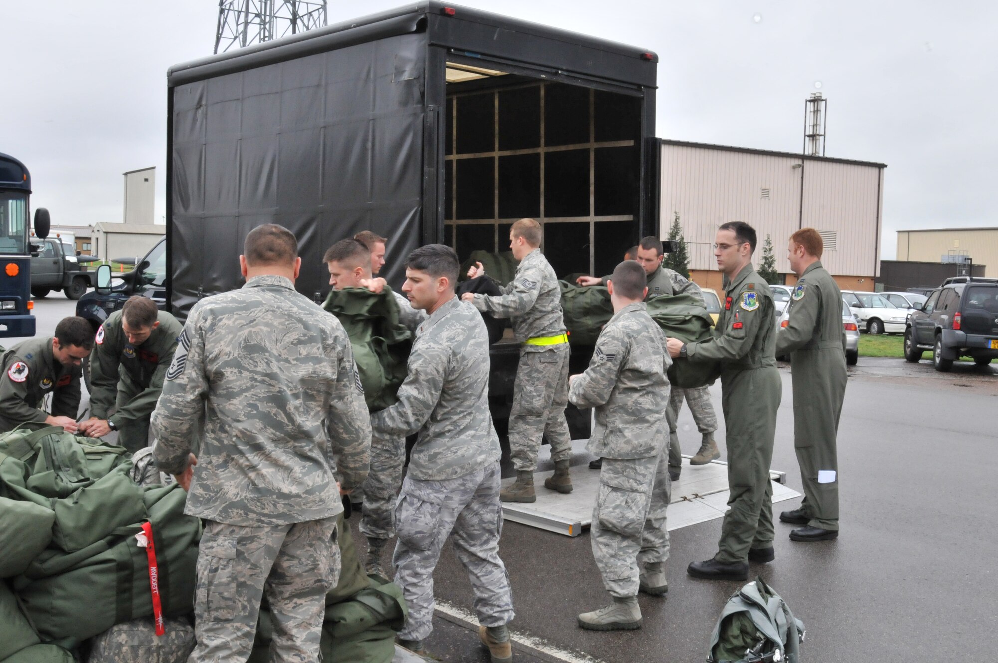 Airmen unload their bags prior to ‘deploying’ during the Phase 1 exercise on RAF Lakenheath, England, Oct. 4. The exercise simulated the preparation and deployment of a large force in response to a contingency. (U.S. Air Force photo/Senior Airman David Dobrydney)
