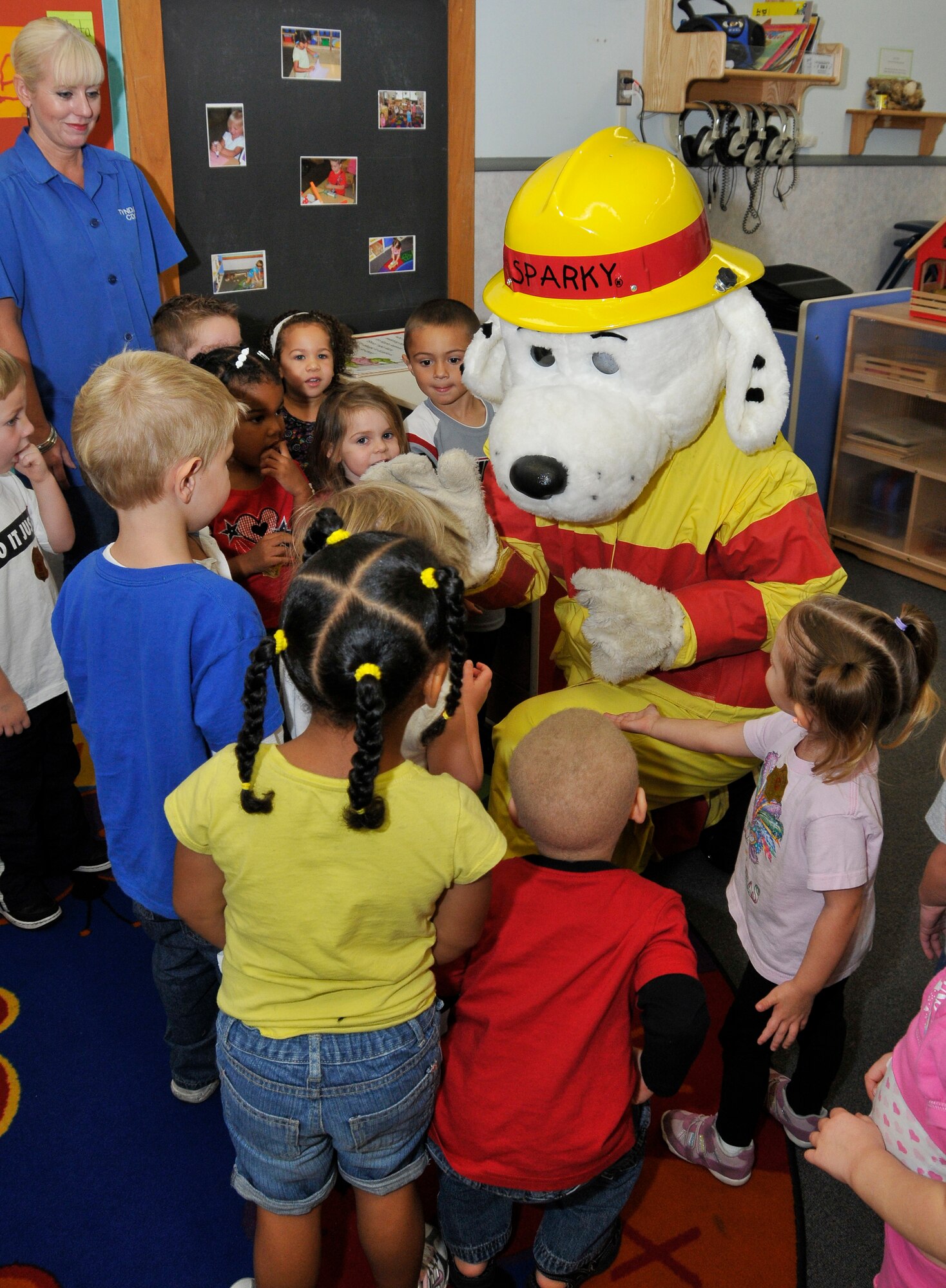 Sparky the Fire Dog pays a visit to Tyndall's Child Development Center Oct. 7 as part of Fire Prevention Week. The children were taught a number of fire safety lessons including the stop, drop and roll technique, how to call 911 in case of an emergency, how to safely exit a house during a fire and much more. Tyndall’s Fire and Emergency Services also stopped at Tyndall Elementary, Tyndall Youth Center and the Base Exchange, to promote fire safety. "The best part of the week, by far, was working with the kids at the CDC and elementary school." said Mr. Michael Newbury, 325th Civil Engineers Squadron fire protection specialist. "That is where we base our education. Kids tend to soak it all in and then take it home to Mom and Dad." This year’s campaign was "Smoke Alarms: A Sound You Can Live With!" (U.S. Air Force photo by Lisa Norman)