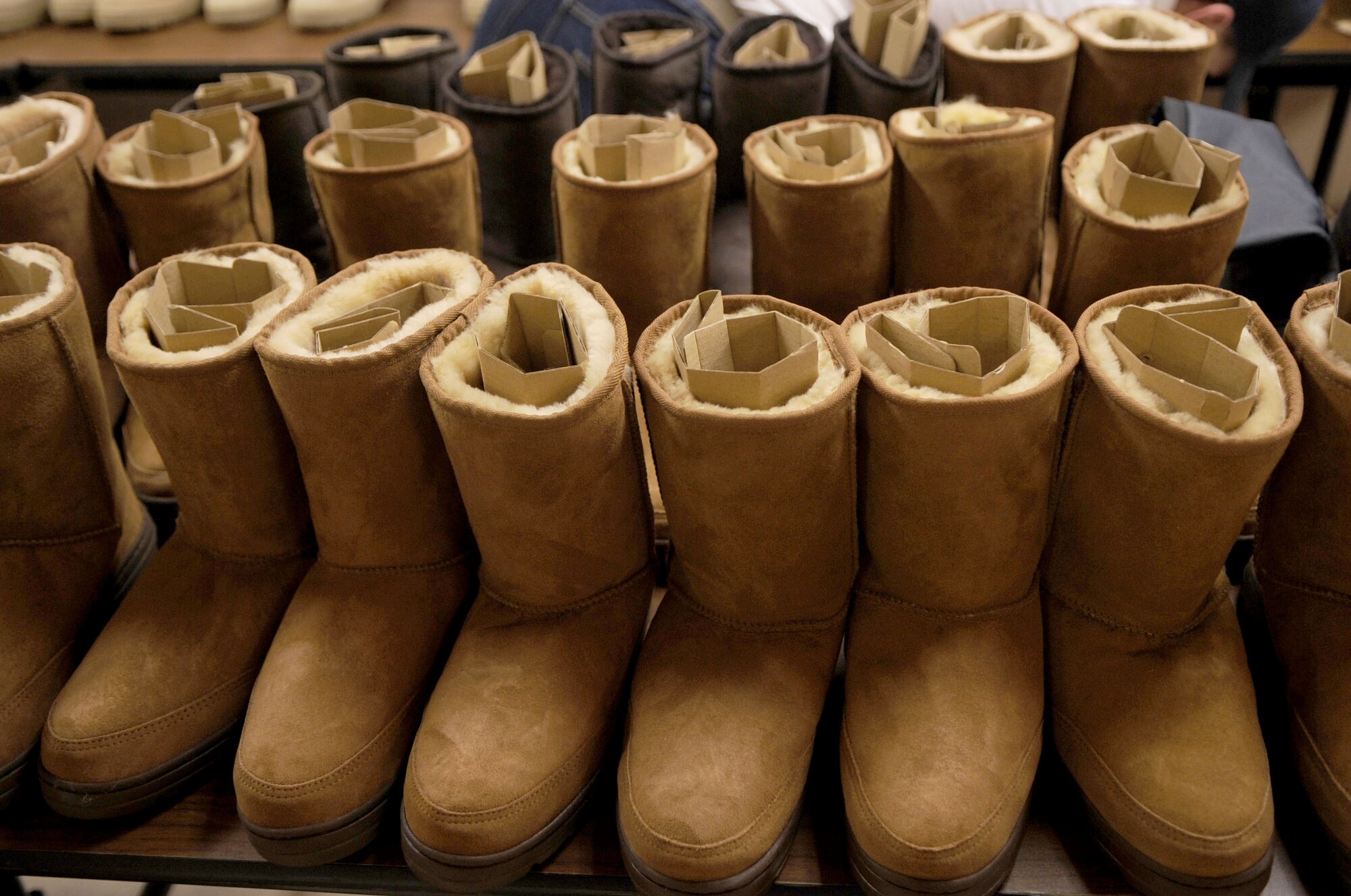 Winter boots are on display before being given to local community members at the Salvation Army’s winter clothing distribution Oct. 6 in Grand Forks, N.D. Volunteers from Grand Forks Air Force Base helped the Salvation Army with set-up, tear-down and handing out winter clothing items.  (U.S. Air Force photo by Senior Airman Amanda N. Stencil)