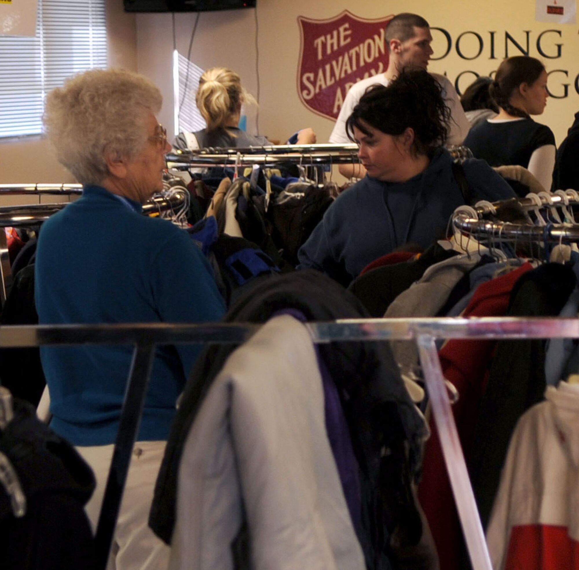Local citizens look around coat racks for winter coats in their size at the Salvation Army’s winter clothing distribution Oct. 6 in Grand Forks, N.D. Volunteers from Grand Forks Air Force Base helped the Salvation Army with set-up, tear-down and handing out winter clothing items.  (U.S. Air Force photo by Senior Airman Amanda N. Stencil)