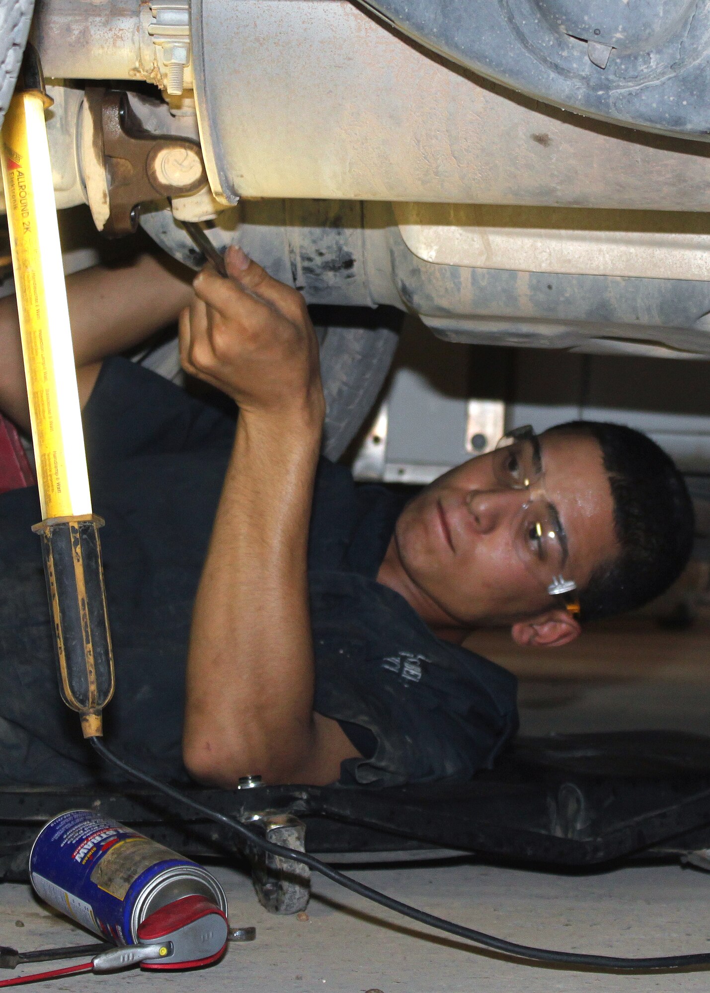 Mohammed Abbas, an apprentice in the 332nd Expeditionary Logistics Readiness Squadron Vehicle Maintenance Flight Iraqi Mentorship Program, removes bolts from the undercarriage of a truck in preparation for a transmission change Aug. 24, 2010, Joint Base Balad, Iraq.  VMF IMP apprentices learn the ins and outs of vehicle maintenance so after graduation they are able to open their own vehicle repair shops or work with other businesses or contractors.  (U.S. Air Force photo/Tech. Sgt. Stacy Fowler)