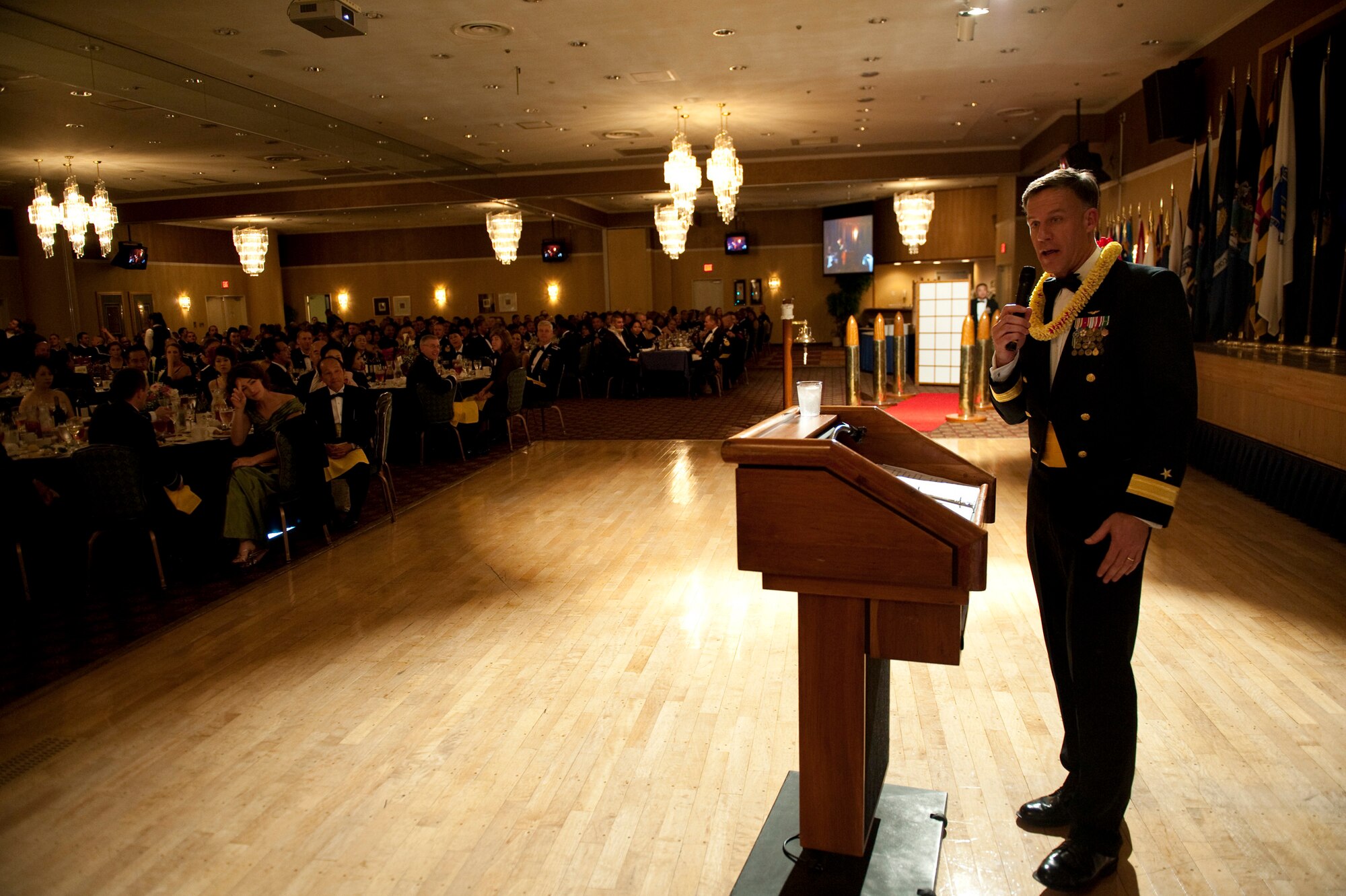 U.S. Navy Rear Adm. Sean Buck, Patrol and Reconnaissance Forces 5th and 7th Fleets commander, gives a speech as guest speaker during the Naval Air Facility Misawa celebration of the U.S. Navy's 235th birthday at the collocated club, Misawa Air Base, Japan, Oct. 8, 2010. Admiral Buck wore a lei presented to him by hula dancers who performed earlier in the evening. (U.S. Air Force photo by Staff Sgt. Samuel Morse/Released)
