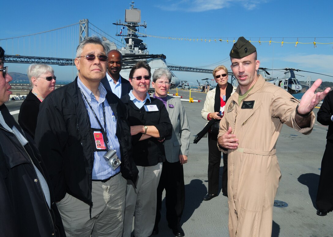 U.S. Marine Corps Maj. Dan Mcguire gives a tour of the Navy's newest amphibious assault ship USS Makin Island to members of the Citizen Emergency Response Volunteers of the Bay Area during San Francisco Fleet Week 2010, Oct. 8, 2010. Mcguire is assigned to Marine Light Attack Helicopter Squadron 367.