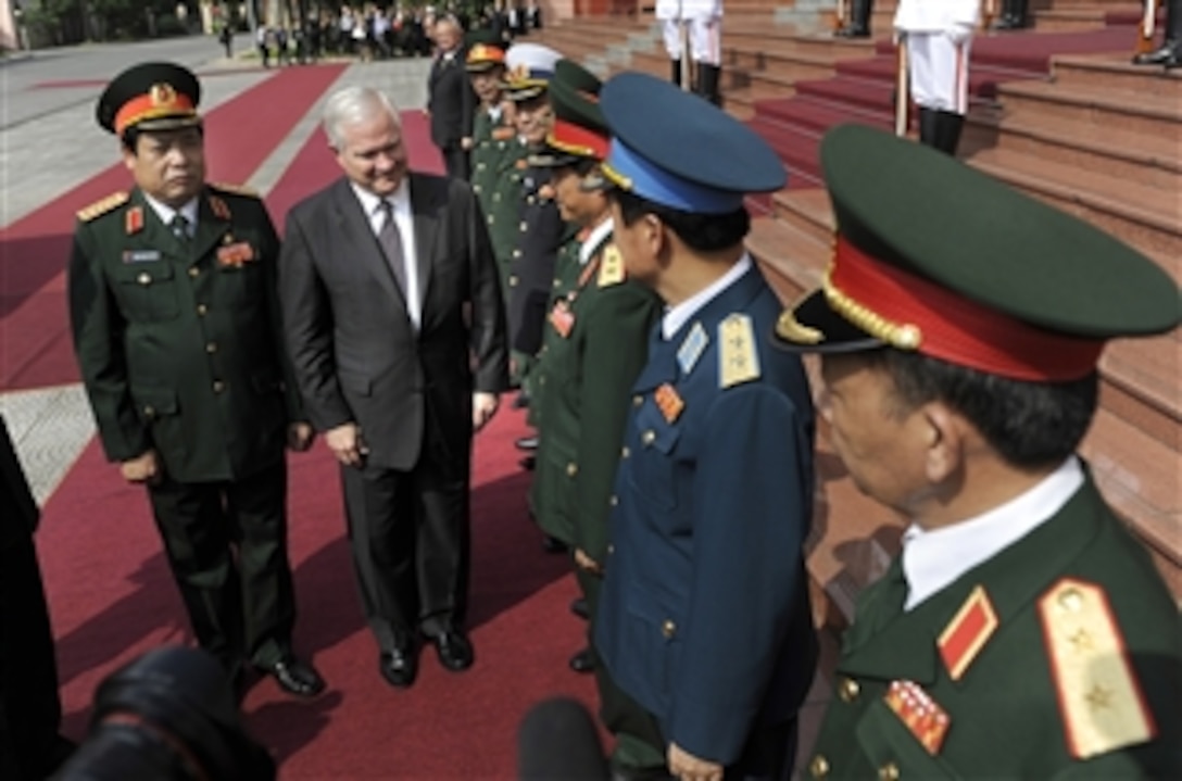 Secretary of Defense Robert M. Gates walks with Vietnamese Minister of Defense Gen. Phung Quang Thanh as they greet respective staffs during a Guards of Honor Ceremony commemorating the official U.S. visit to the Vietnamese Military headquarters in Hanoi, Vietnam, on Oct. 11, 2010.  