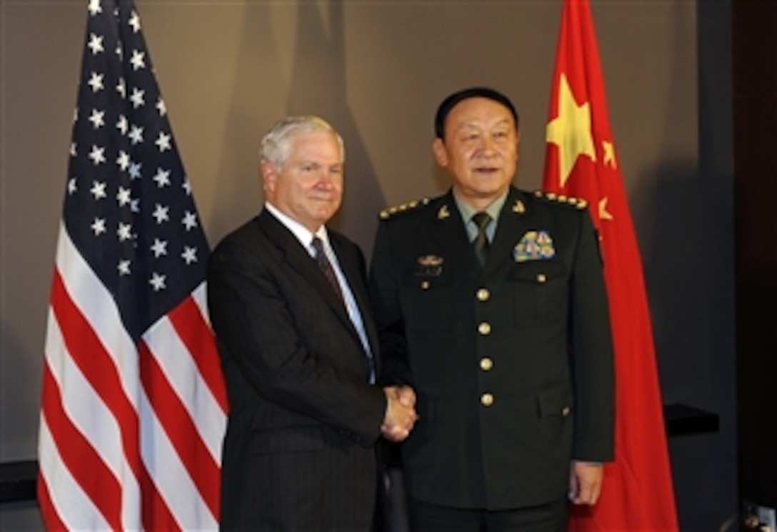 Secretary of Defense Robert M. Gates and Chinese Minister of Defense Liang Guanglie shake hands and pose for the press in Hanoi, Vietnam, on Oct. 11, 2010.  