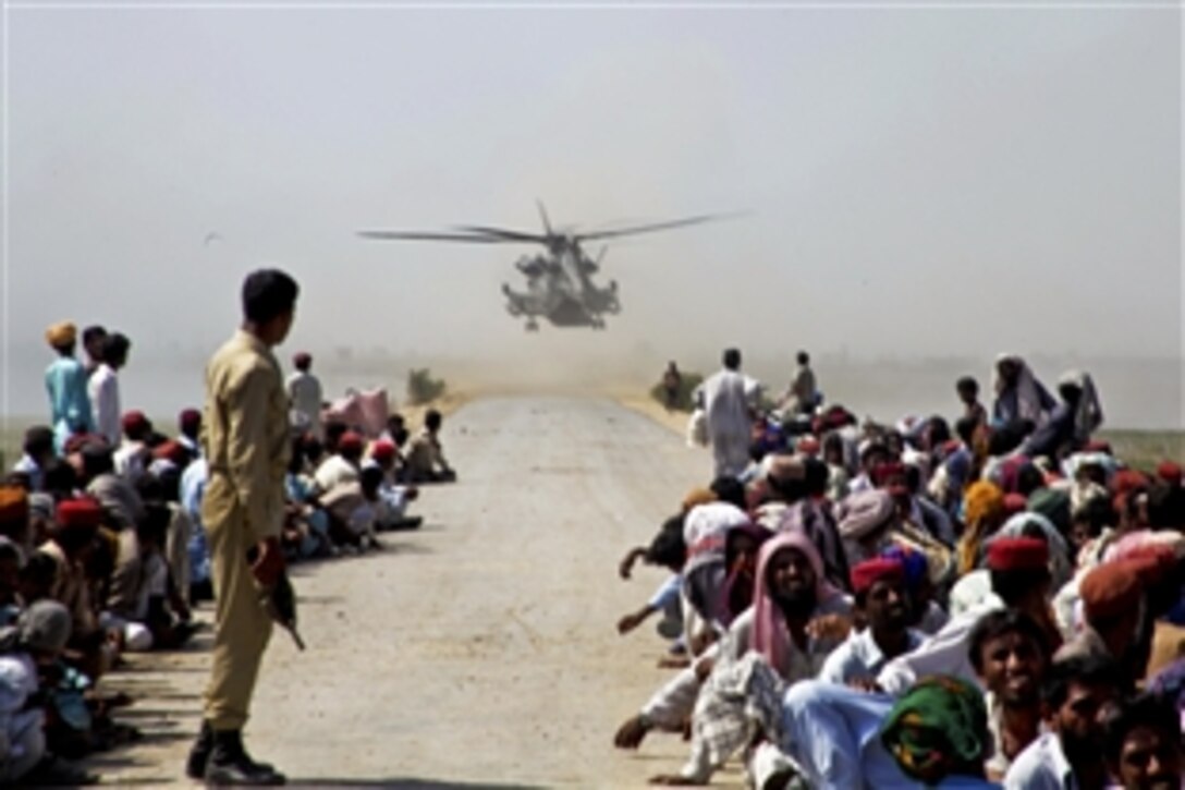 U.S. Marines land in a CH-53E Super Stallion helicopter in a flood-affected area to deliver food during relief operations in Pano Aqil, Pakistan, Oct. 12, 2010. The Marines are assigned to the Marine Medium Tilt Rotor Squadron 266, 26th Marine Expeditionary Unit.