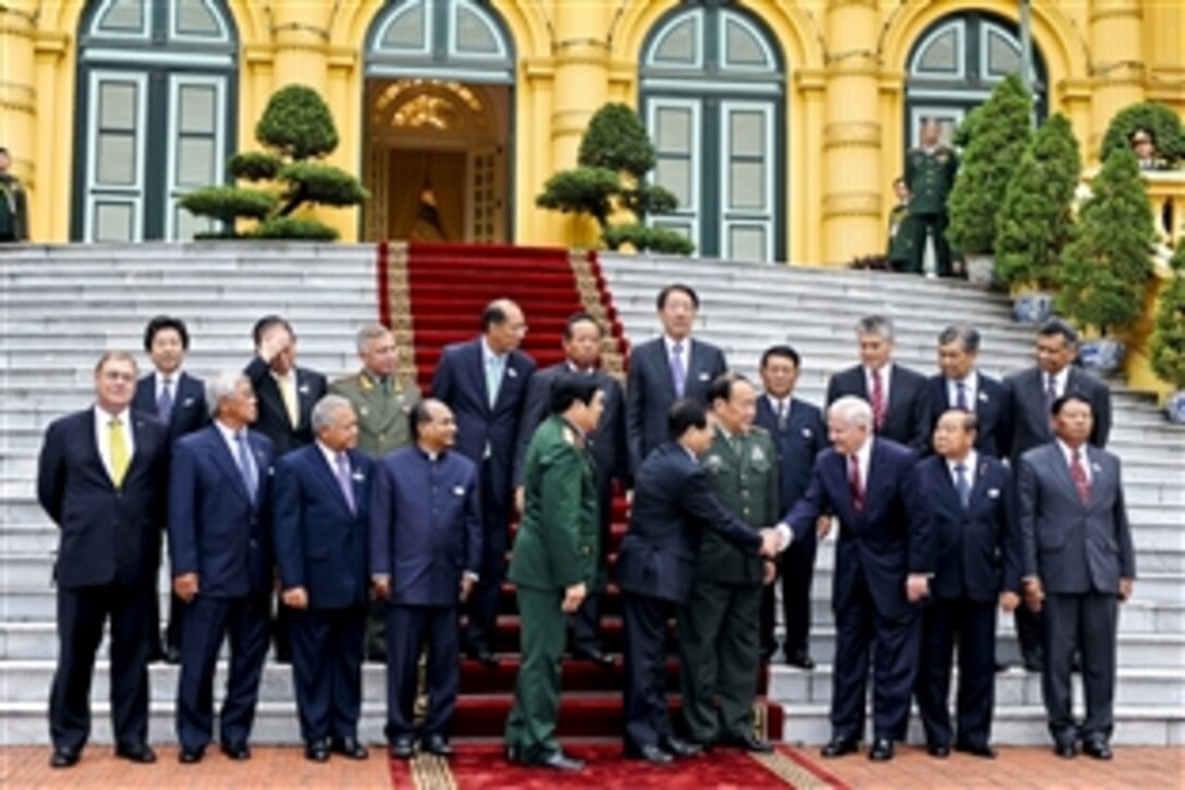 U.S. Defense Secretary Robert M. Gates, third from right in front, and Vietnam President Nguyen Minh Triet, fifth from right, gather on the front steps of the Presidential Palace during the first "plus" defense ministers meeting of the Association of Southeast Asian Nations in Hanoi, Vietnam, Oct. 12, 2010.
