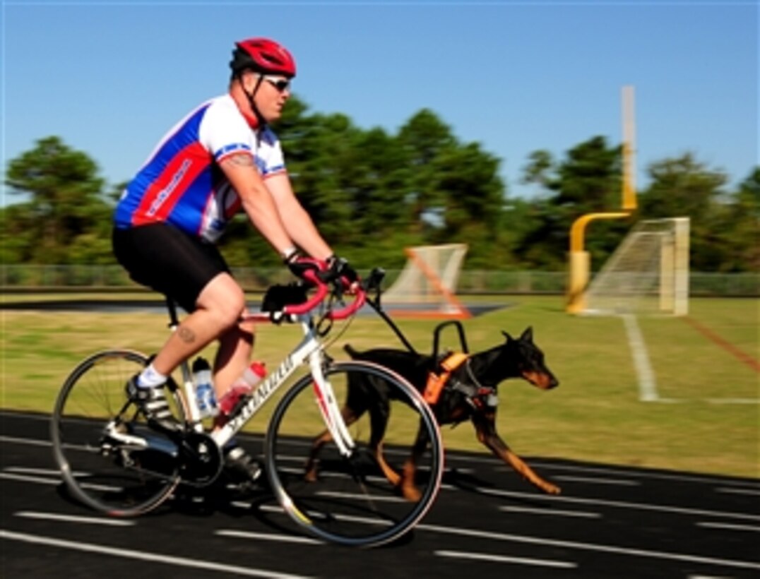 U.S. Marine Corps Gunnery Sgt. Daniel P. Frawley rides in the 2010 Warrior Ride at Wilmington, N.C., with his dog Poncho on Oct. 7, 2010.  The Warrior Ride is a three-day rehabilitative cycling program for wounded veterans from all military services.  