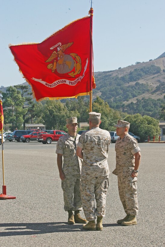 Master Gunnery Sgt.::r::::n::Theodore E. Butenas, sergeant major, Mobilization Training Battalion, 43, from Pleasantville, Mo., stands at the position of attention after delivering the ceremonial colors to the former MTBN commanding officer Maj. Mark A. Shuster, as Lt. Col. Thomas C. Gresser, MTBN’s new commanding officer takes charge during the change-of-command ceremony at Camp Pendleton, Oct. 12.